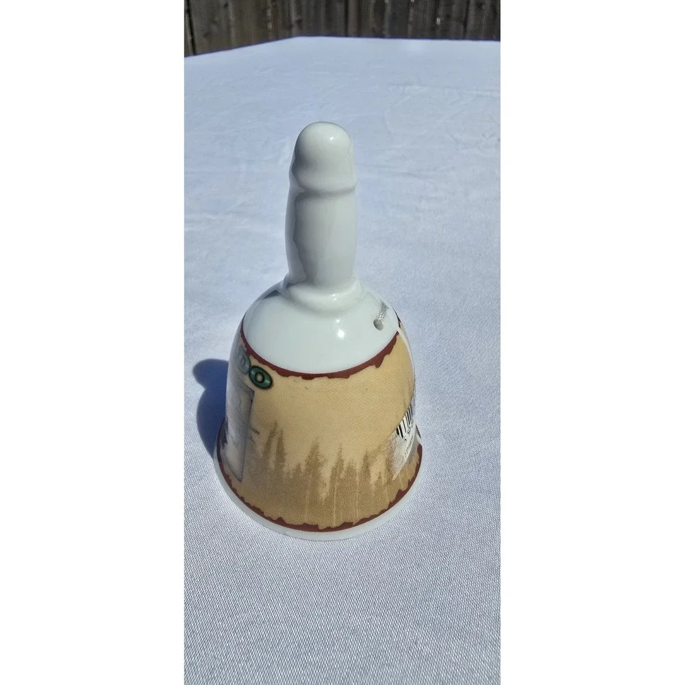 vintage/collectible porcelain souvenir bell featuring a map graphic of Colorado